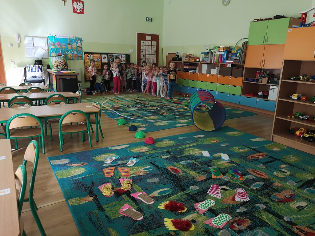 Dzieci z grupy Wiewiórek podczas obchodów Dnia Przedszkolaka pokonujące tor przeszkód.